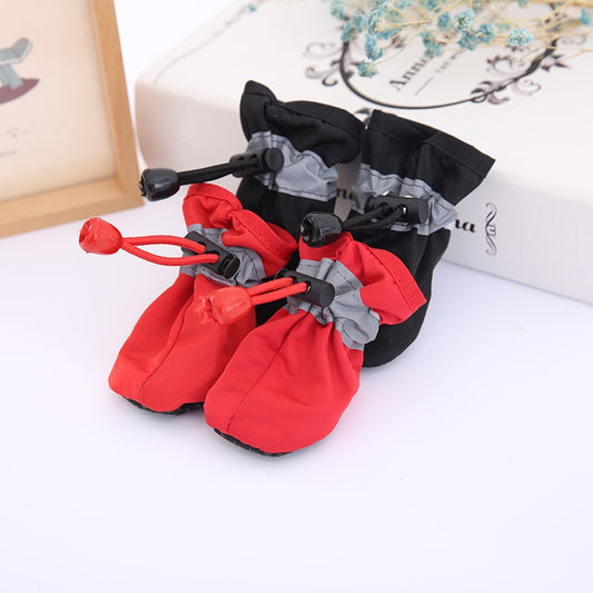 set of 4 dog waterproof shoes 1 pair at the rear is black the second pair at the front is red